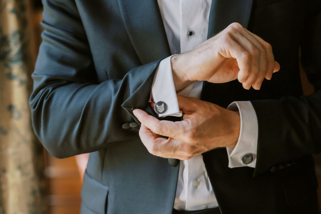 Groom adjusting cufflinks